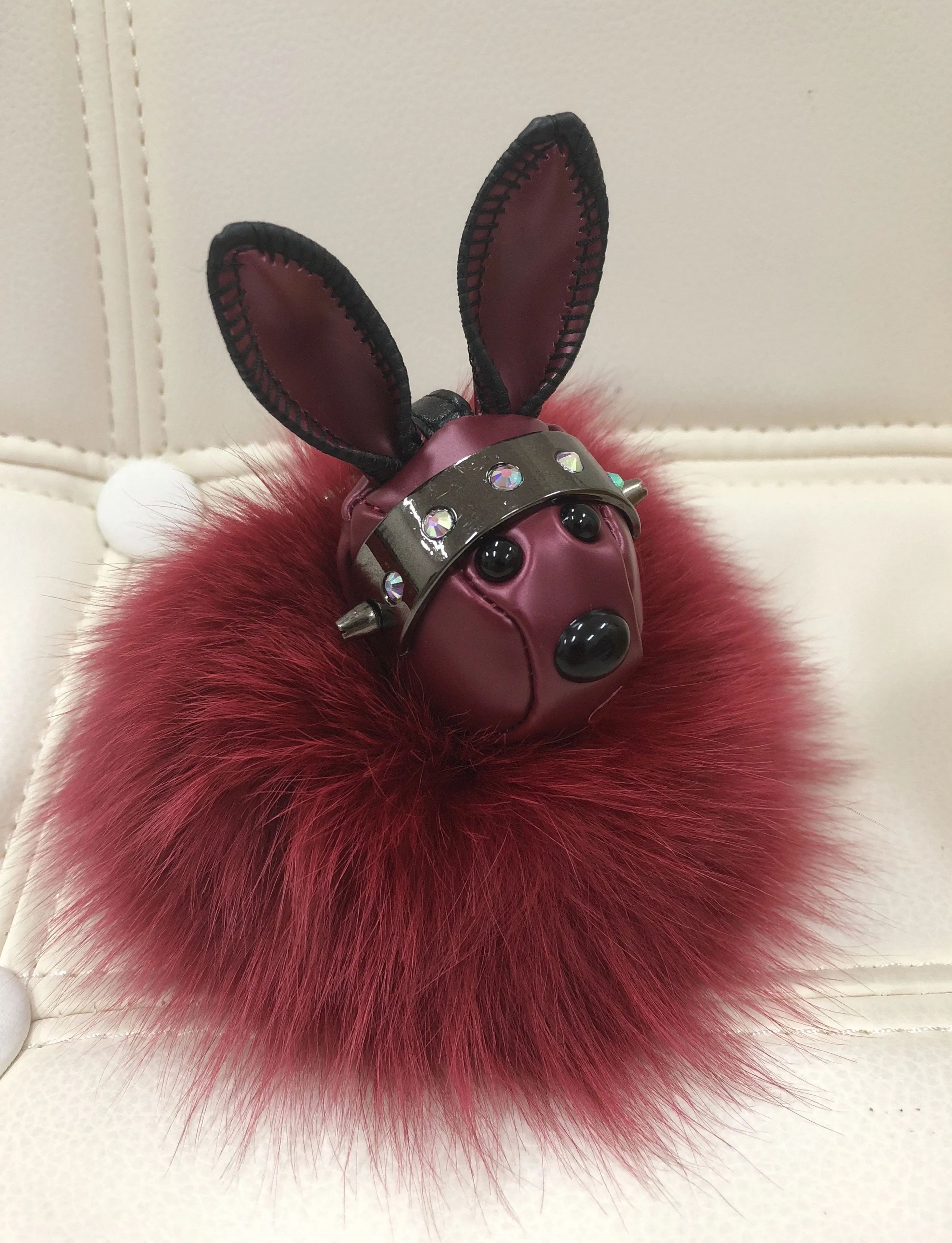 Leather rabbit with fur ball bag charm gold/maroon color